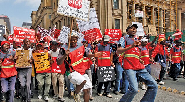 Striking Cosatu members … The federation accuses labour brokers of lowering wages and quality of employment and wants them banned